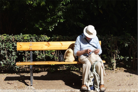 Dementia, elderly man sitting on a bench