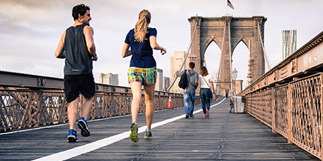 people running over a bridge