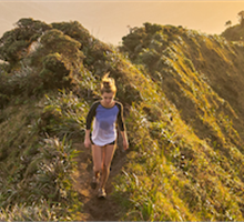 BRHP, woman walking on the top of a grassy hill