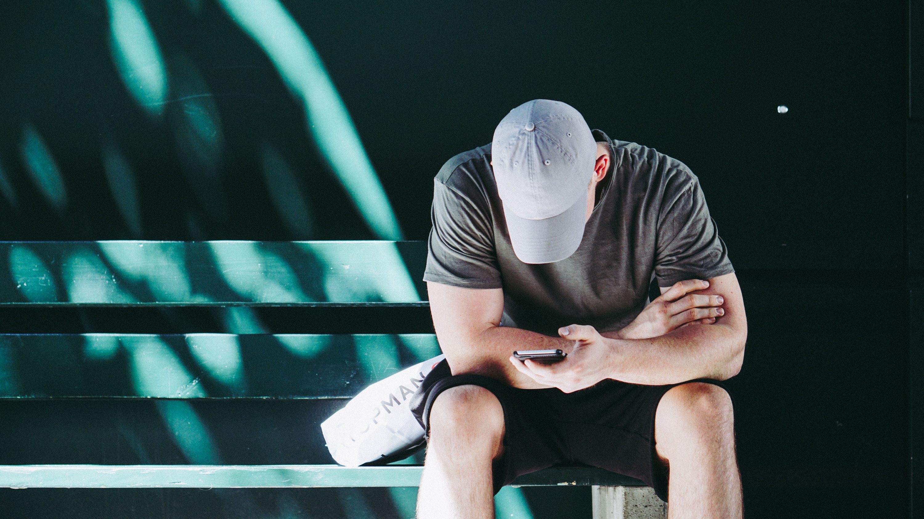Young man sitting looking at his phone