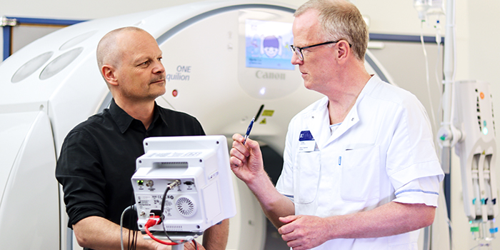 Hjertecentret på Rigshospitalet og DTU Compute skal sammen ved hjælp af et unikt dansk datasæt med patientundersøgelser indsamlet gennem mere end 10 år undersøge, om kunstig intelligens (AI) kan afsløre nye og hidtil ukendte tegn på hjertekar-sygdommene hjertestop og stroke. Her læge i Hjertecentret på Rigshospitalet Klaus Fuglsang Kofoed og lektor Rasmus R. Paulsen fra forskningssektionen Visual Computing på DTU Compute. Foto: Rigshospitalet.