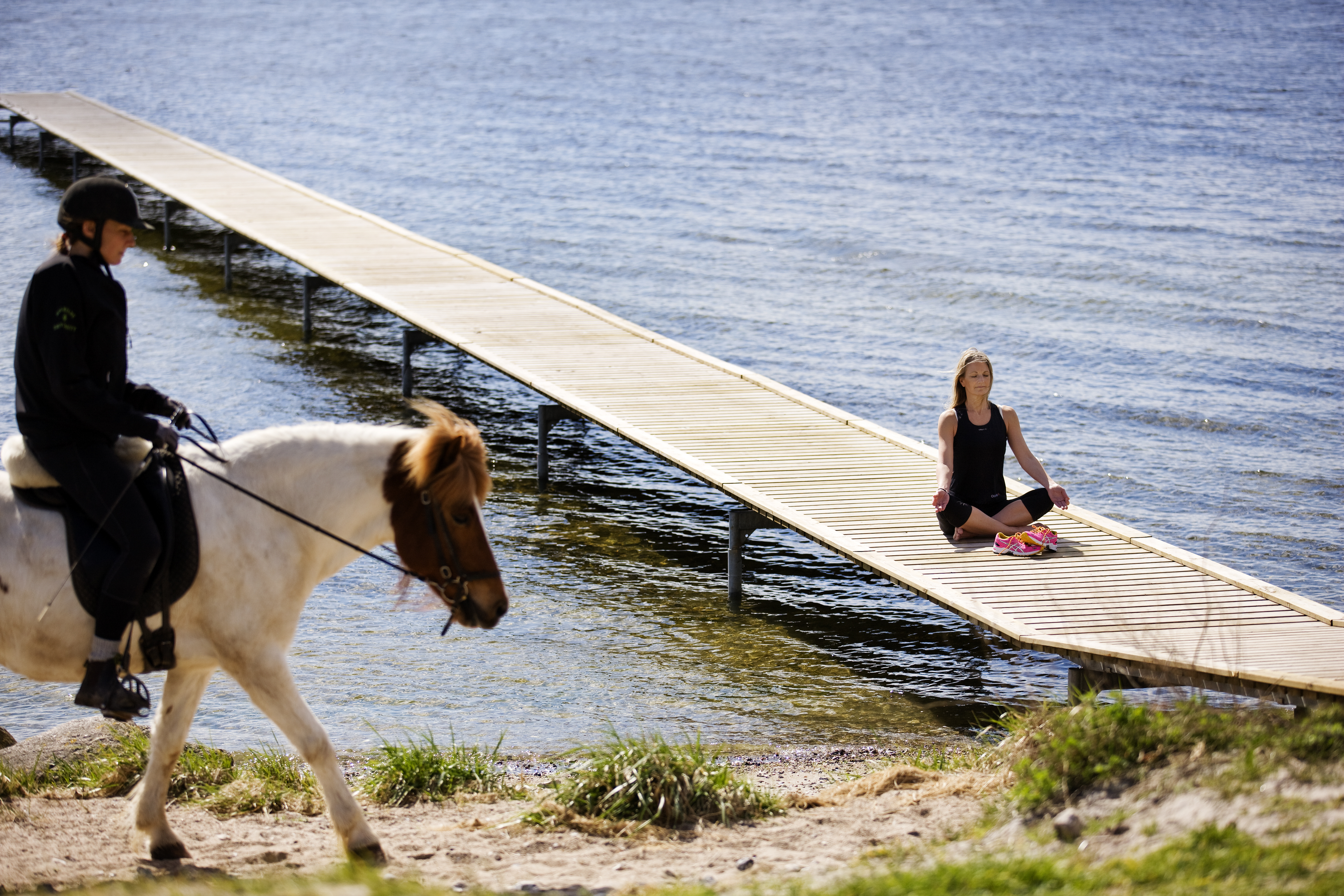 Woman meditating by water and a woman horseback riding