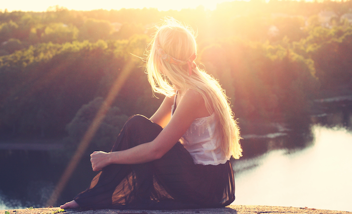 TEAM, girl sitting by a lake