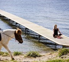 Woman meditating by water and a woman horseback riding