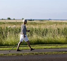 elderly person power walking down the country side
