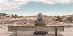 elderly woman sitting on a bench